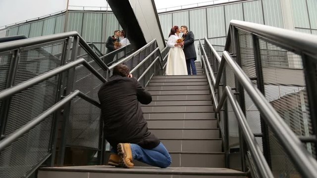 Photographer taking pictures couple of newlyweds
