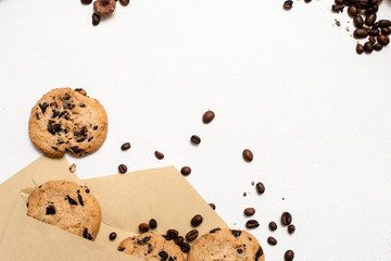 Fond of sweets and bakery shops concept. Small elegant presents with home-baked chocolate scones and coffee seeds decoration on white background, top view with free space