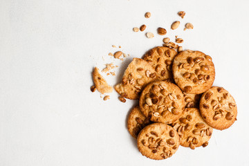 Culinary background of wholegrain cookies. Delicious homemade sweets on white table, top view with free space