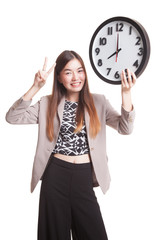 Young Asian business woman show victory sign with a clock.