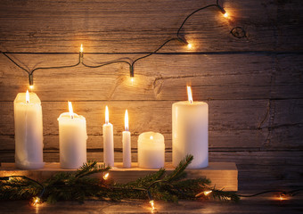 Christmas candles on wooden background