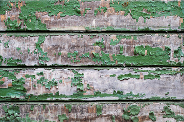 Old small wooden boards with peeling green paint