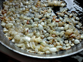 Onion being fried on a pan
