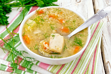 Soup fish with millet and spoon on light board