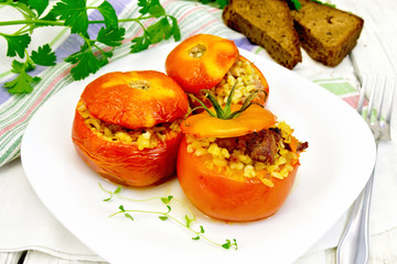 Tomatoes stuffed with bulgur in plate on table