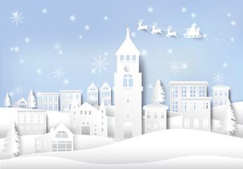 Obraz na płótnie Canvas Winter holiday, santa and snowflake in city town paper art background. Christmas season paper cut style illustration