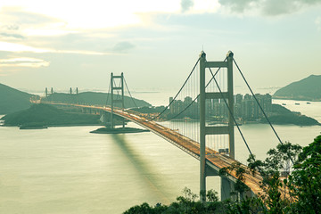 Fototapeta na wymiar silhouette Tsing Ma double-decked suspension bridge between Ma Wan island and Tsing Yi island in Hong Kong, China at sunset and vintage tone