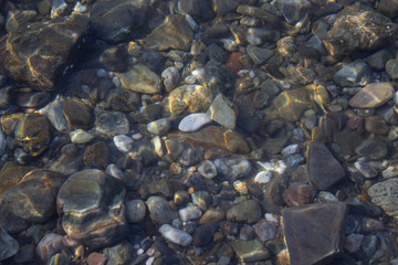 The seabed of colored pebbles near the shore