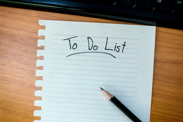 top view of work desk with writing to do list in paper