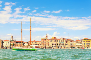 Colorful summer view of Venice from water side, with famous canals, large sailboat and colorful historical buildings