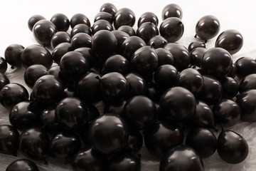 Black inflatable balls for the holiday. In studio on a white background.