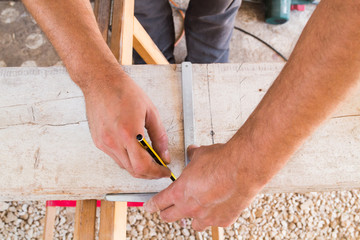 Carpenter working on raw wood / boards / plank.