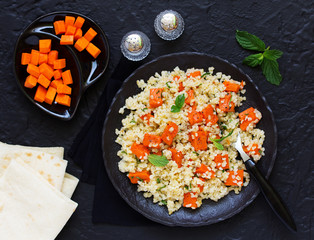 Salad with bulgur and baked pumpkin.