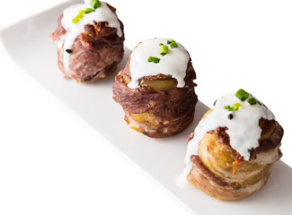 potato wrapped in bacon baked with cheese