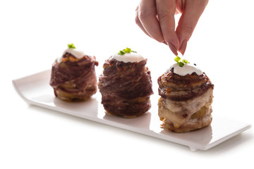 the cook sprinkles with green baked potatoes