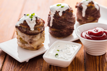 potato wrapped in bacon baked and sauces