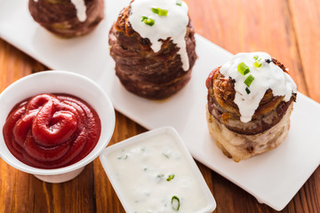 potato wrapped in bacon baked and sauces