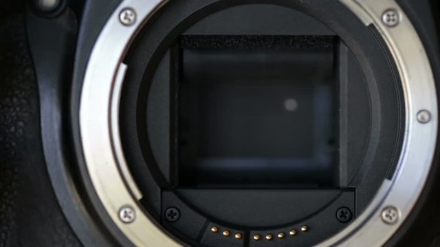 Continuous shooting, shutter curtains in the camera. Close up.