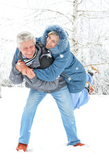 Man giving piggyback ride to woman 
