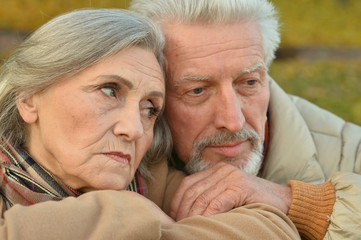 Sad senior couple in  park