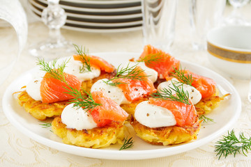 Appetizer of hash browns and red fish.
