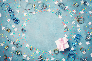Party, carnival or birthday frame with colorful confetti, gift box and streamer on vintage blue...