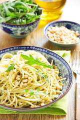 Spaghetti with pesto of arugula with pine nuts.