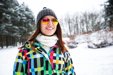 Fototapeta na wymiar Portrait of beautiful woman at winter snow mountain