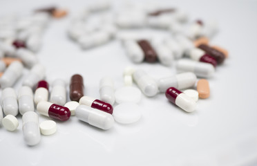many different red, white, brown, medicine pills, isolated, white background