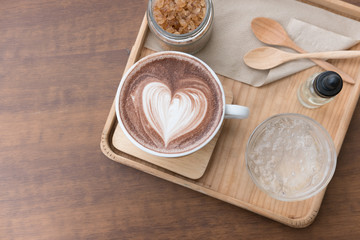 Fototapeta na wymiar hot chocolate drink with heart latte art. delicious cocoa beverage serve with flavor and brown sugar