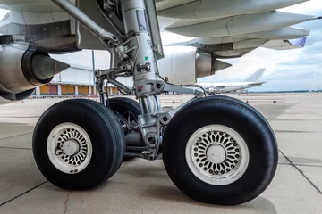 Fotobehang close up of airplane wheel parked at the airport © Siraphatphoto