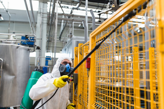 Pest Control Worker Hand Holding Sprayer For Spraying Pesticides in production or manufacturing factory