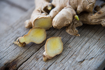 Fresh ginger on wood texture.