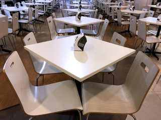 Tables and Chairs Line Up in a Cafeteria