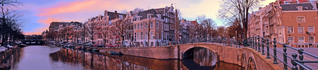 Poster Panorama from the city Amsterdam in the Netherlands at sunset © Nataraj