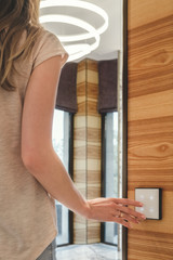 the girl turns on the light presses on the touch switch