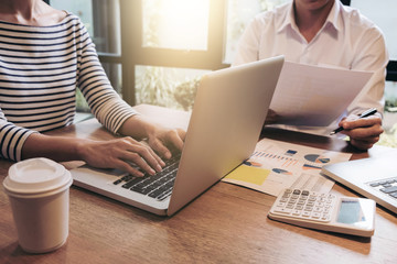 Two businessmen at work, Business crew working with new startup financial project plan,man and woman discussion information with laptop and digital tablet in a modern business lounge,Selective Focus