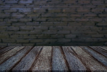 Empty wooden table and blur background of abstract in front of wall texture or old black brick wall can be used Mock up for display of product or for montage