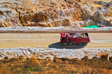 Fototapeta premium The red dump truck. Kaolin quarry. Vetovo village area, Bulgaria.