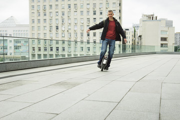 Man on electronic unicycle moving freely in the city © ninelutsk