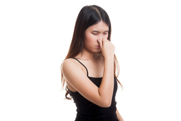 Young Asian woman  holding her nose because of a bad smell.