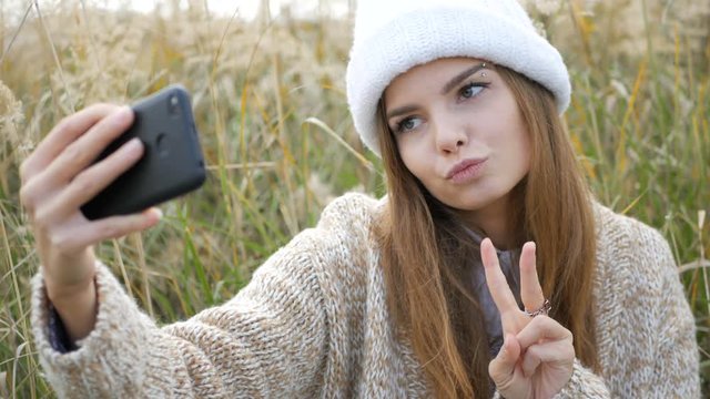 beautiful woman taking selfie using phone enjoying nature and lifestyle on vacation