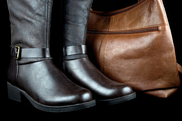 Leather Boots and Bag on Black Background