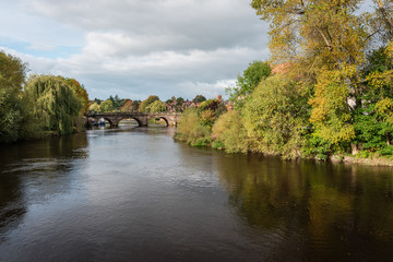 Fototapeta na wymiar View along the river Severn towards the Welsh bridge with autumn colours, Shrewsbury, Shropshire, UK.