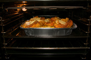 home cooking potatos with chicken in oven. Selective focus