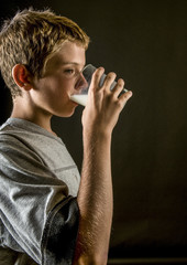 Young teen boy drinking milk