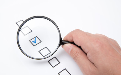 Checklist on white paper with Magnifier