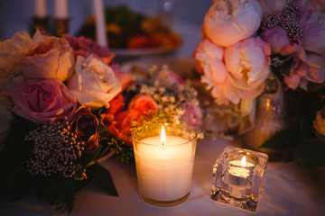 Table decor with white flowers and candles for a wedding party
