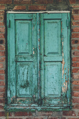 Shuttered Window On Old Brick Wall.