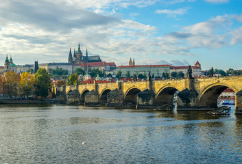Prague Castle and Charles Bridge in Prague, in the Czech Republic at sunset. St. Vitus Cathedral. The Vltava River.